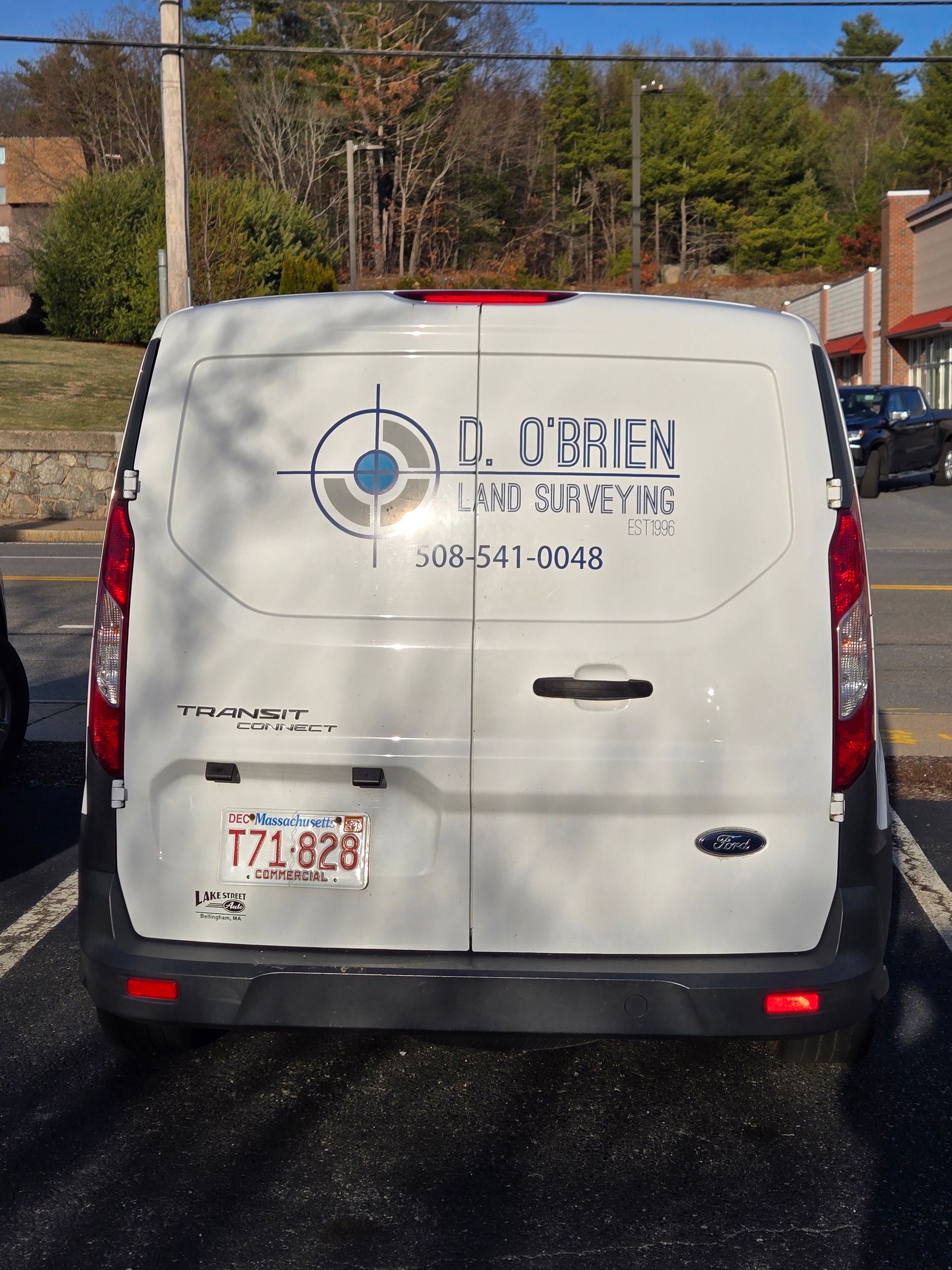 A white van is parked in a parking lot
