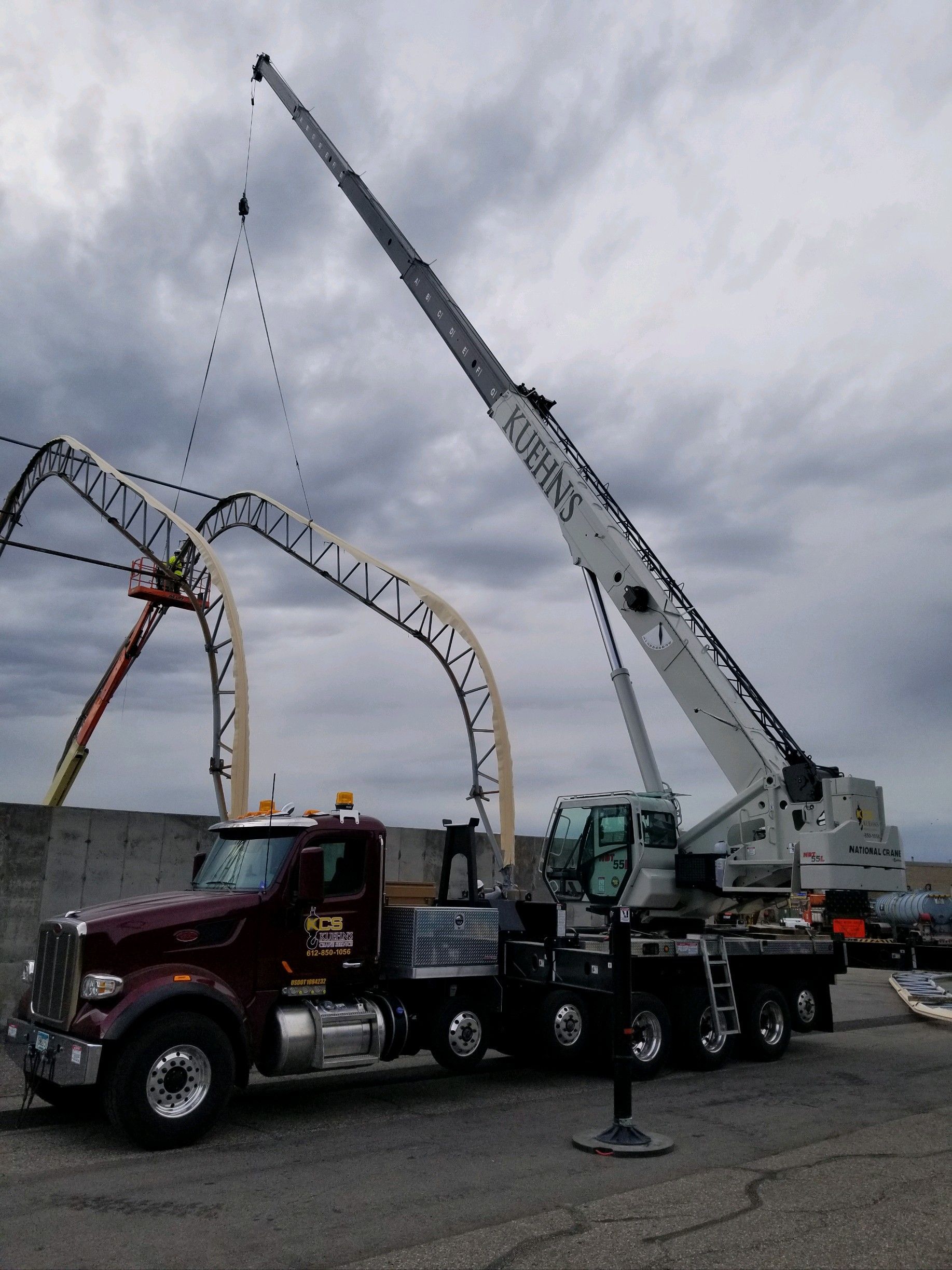 A large crane is attached to the back of a truck