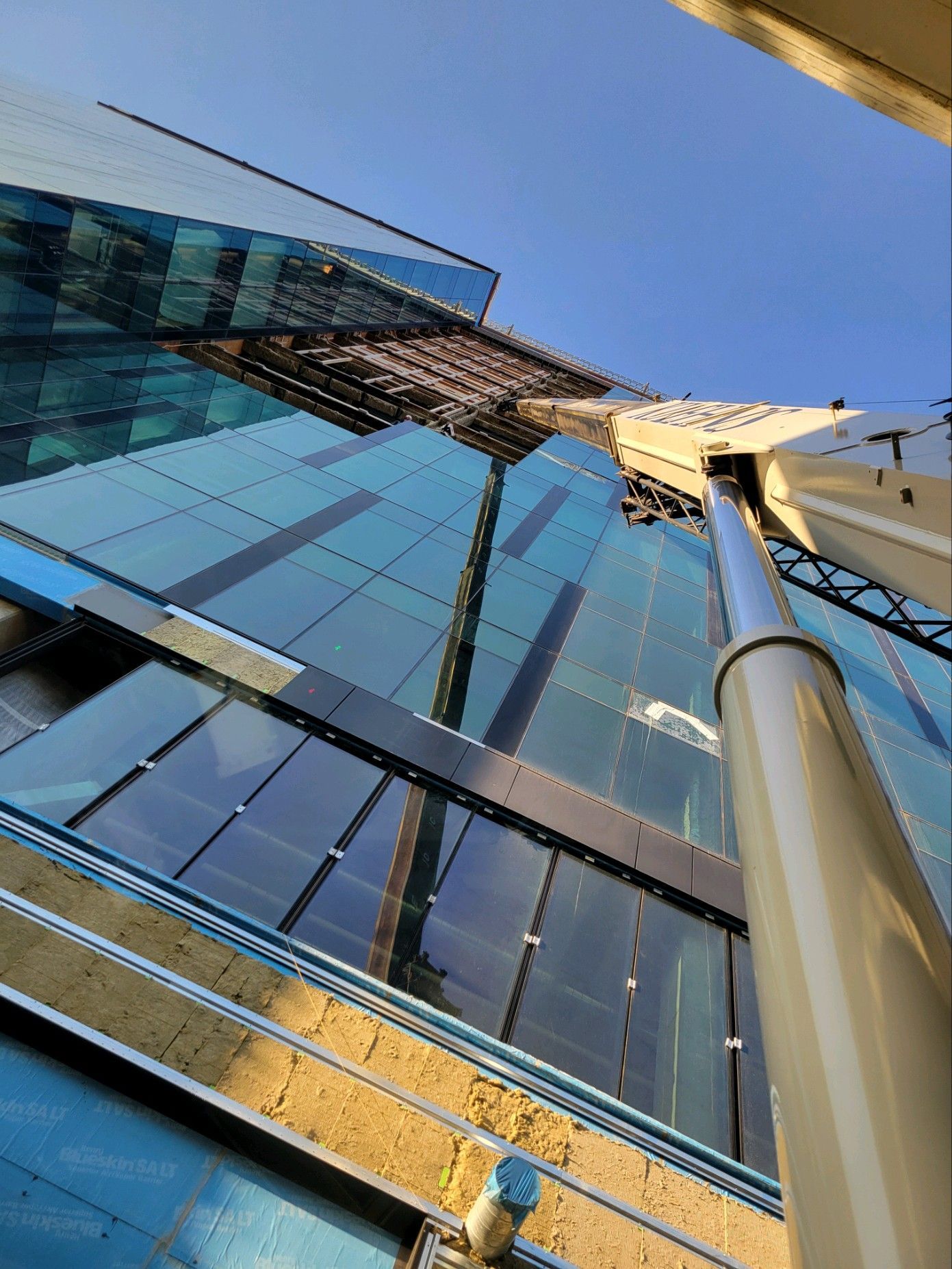 Looking up at a tall building with a blue sky in the background
