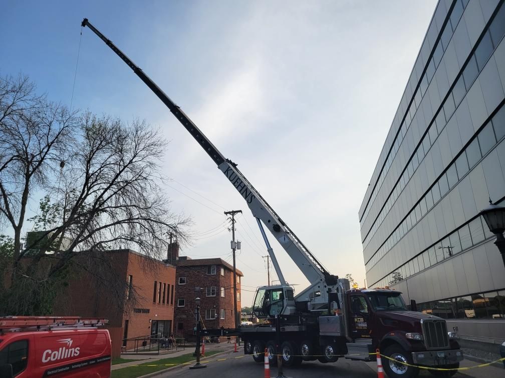 A collies truck is parked in front of a building