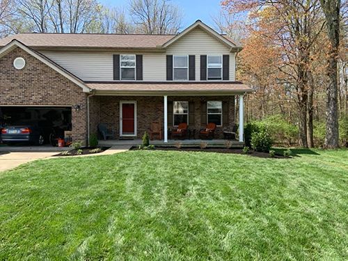 A large house with a large lawn in front of it.