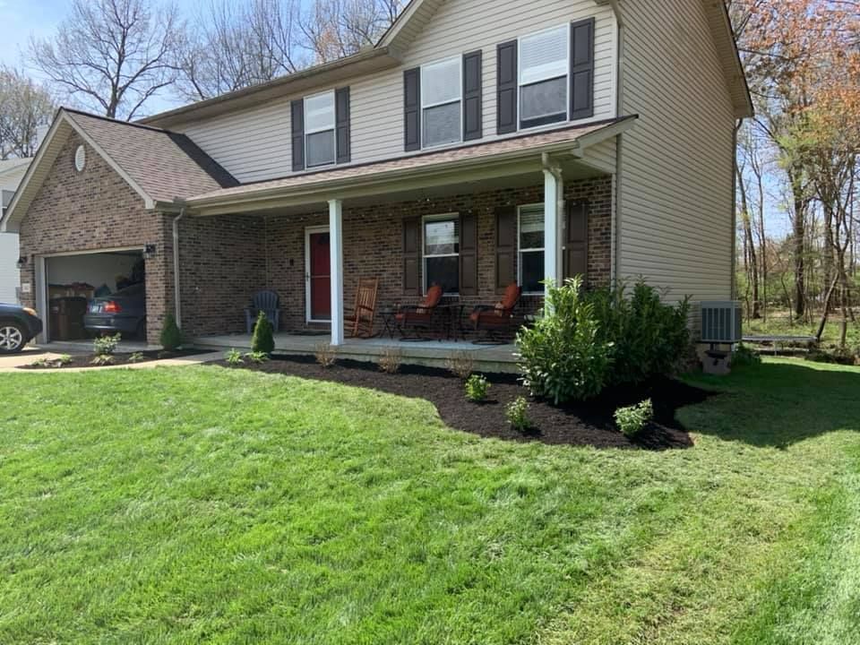 A large house with a porch and a car parked in front of it.
