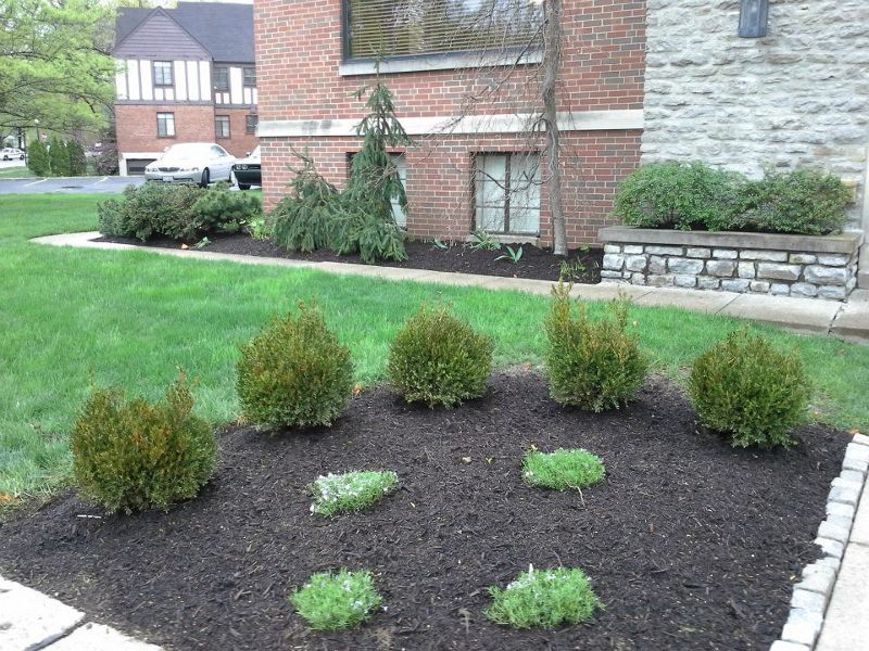 A brick house with a garden in front of it
