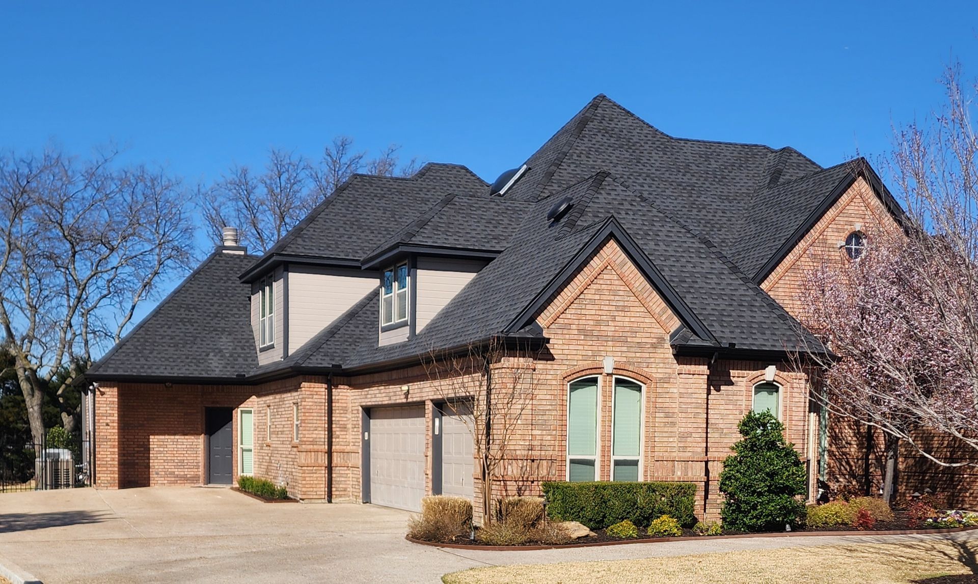 A large brick house with a black roof