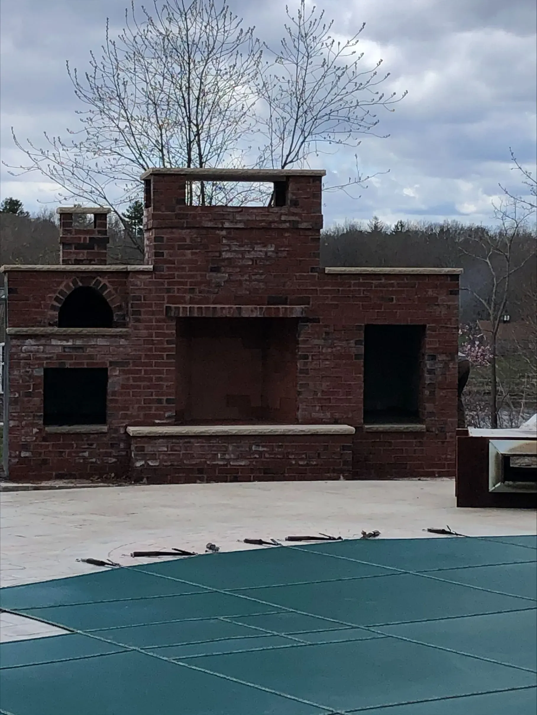 A brick building with a swimming pool in front of it.