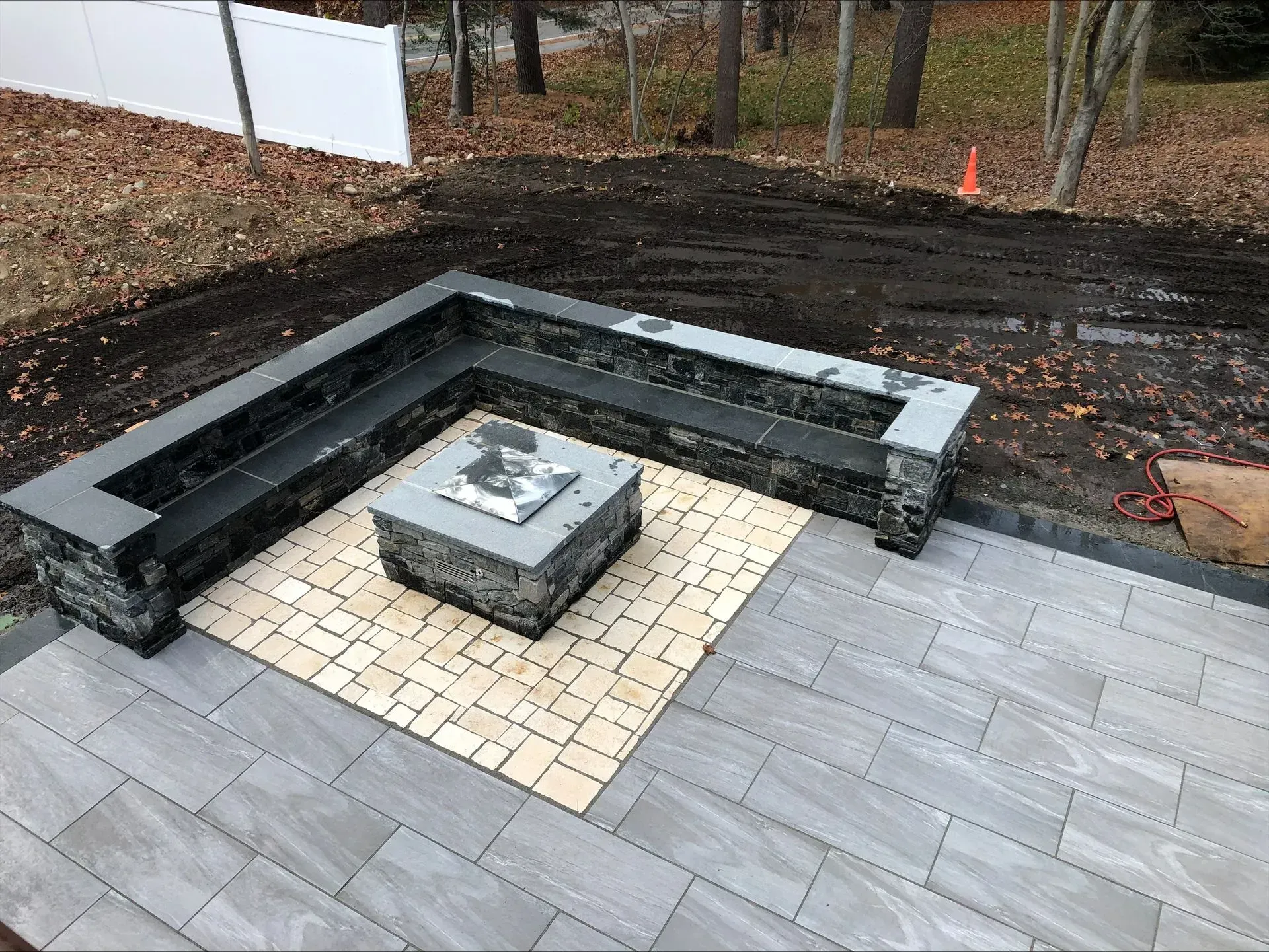 There is a fire pit in the middle of the patio.