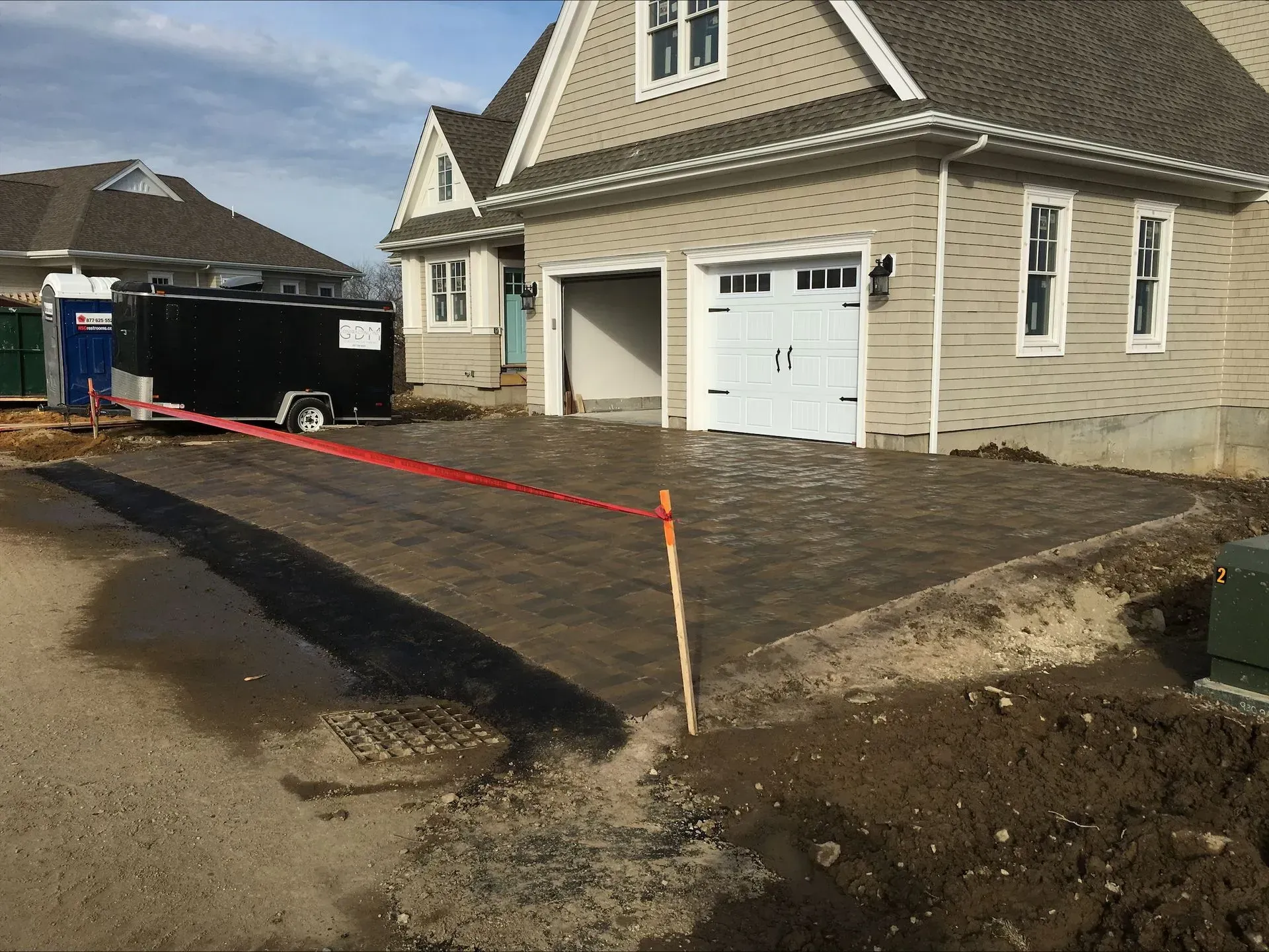 A house with a garage and a trailer in front of it.