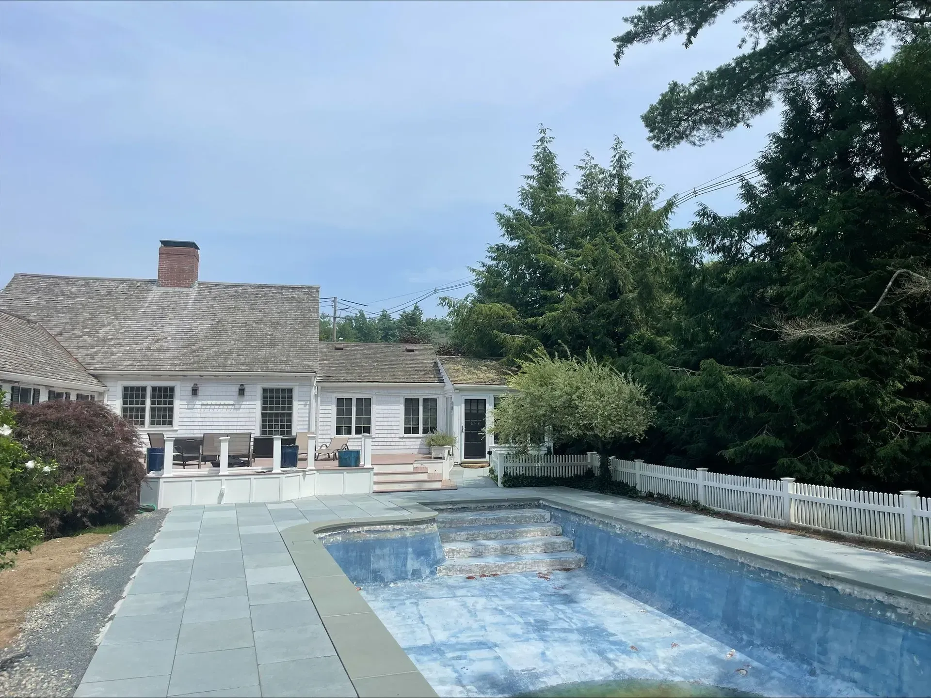 A large white house with a swimming pool in front of it