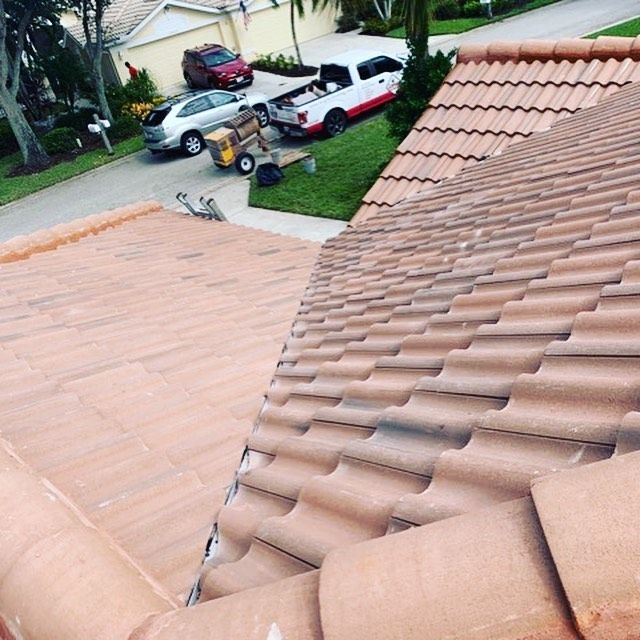 The roof of a house with cars parked in front of it