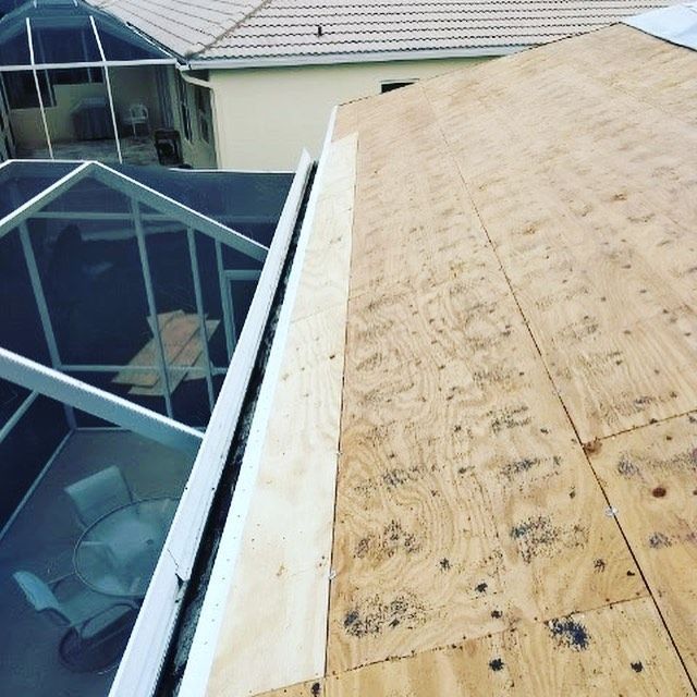 A house with a roof that is covered in plywood