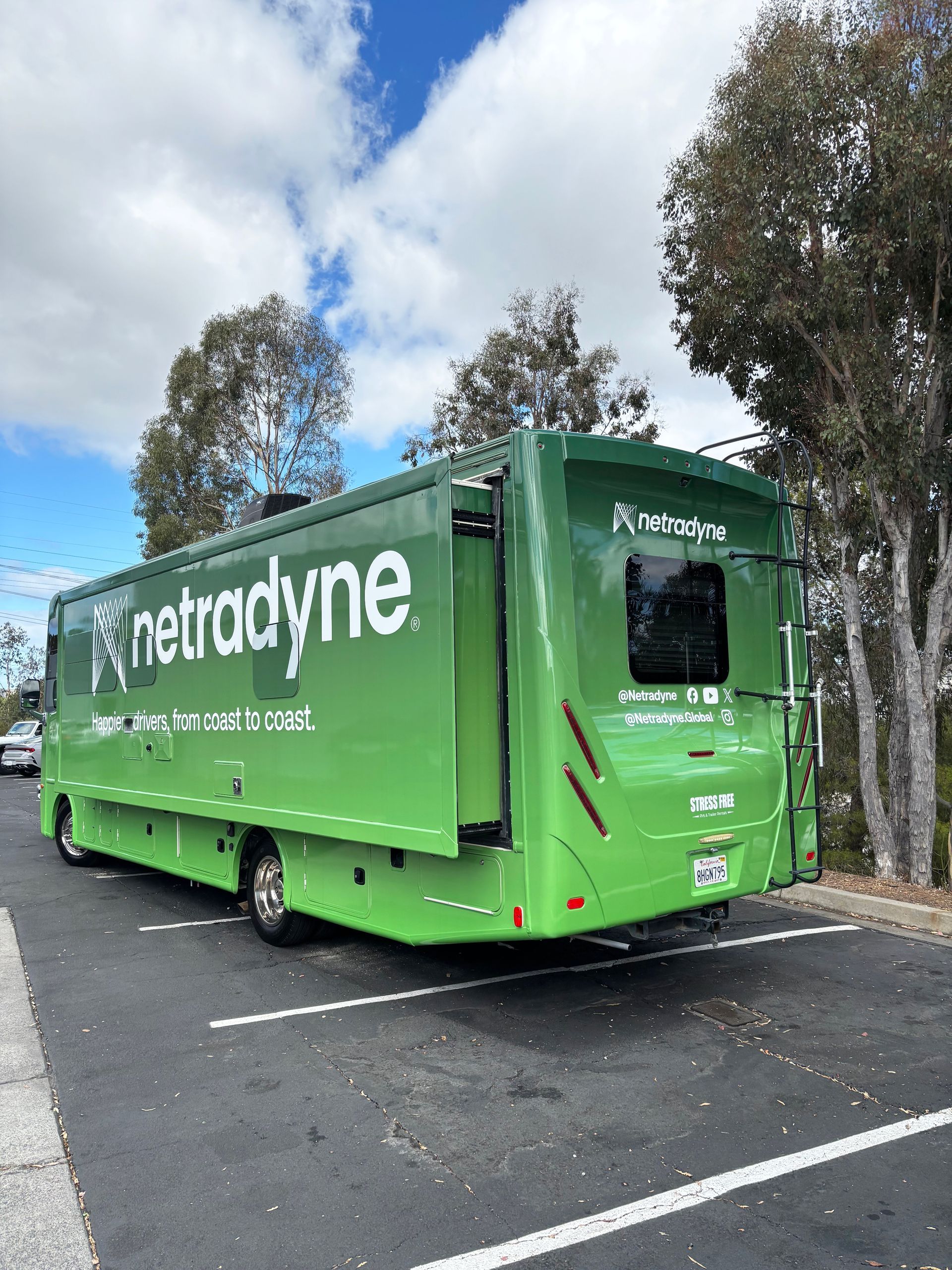 Green Retrodyne truck parked in a lot under cloudy skies