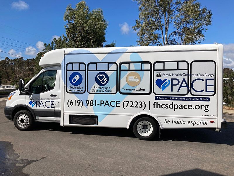 PACE transit bus with blue service logos parked outdoors on a sunny street