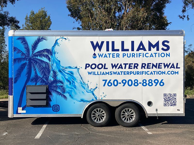 Williams Water Purification pool water renewal truck with palm tree graphic and phone number on a white trailer