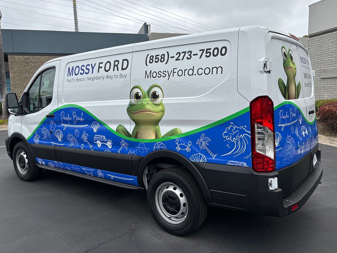 White Nossy Ford van with turtle graphics and blue wave design parked in a lot