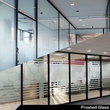 Modern office hallway with frosted glass partitions and a glass-walled meeting room