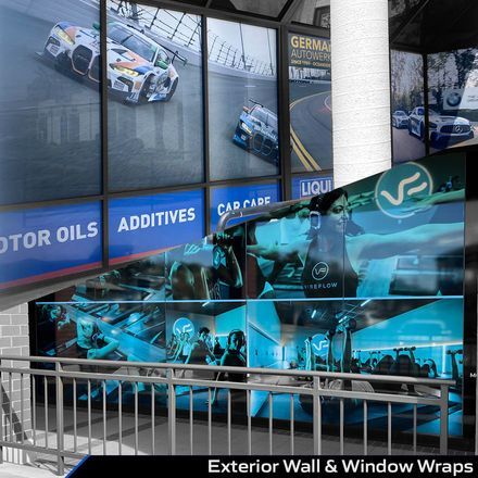 Race car-themed exterior wall and window wraps in blue tones on a building facade