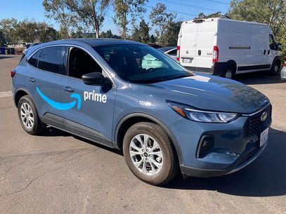 Blue Amazon Prime delivery SUV parked outdoors on a sunny lot