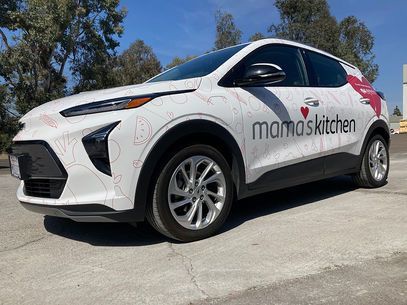 White Mamas Kitchen delivery SUV parked outdoors on a sunny day