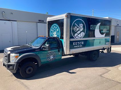 Green Ketch Food Truck parked outside a building, with fish logos and teal branding