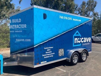 Blue Nucave Construction trailer parked outdoors with white text and logo