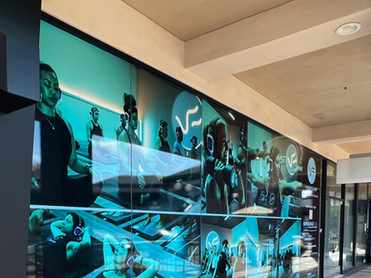 Blue-toned mural of musicians and instruments on a hallway wall