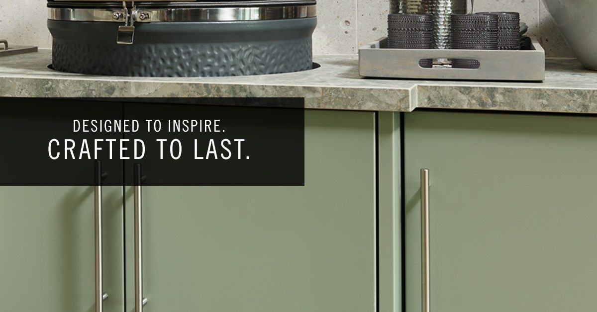 Green kitchen cabinets with metal handles; text reads 
