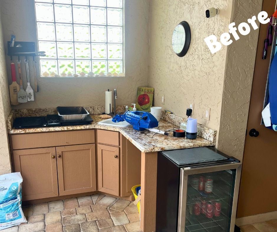 Outdoor kitchen with counter, cabinets, and appliances. 