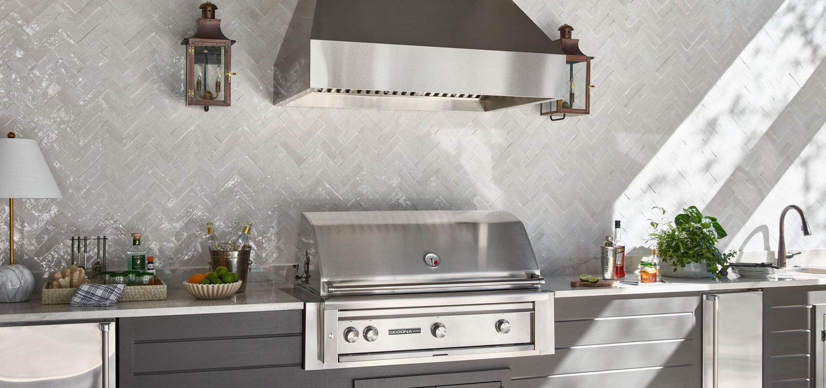 Gray roof with multiple gables, small windows, and wooden trim on a white building.