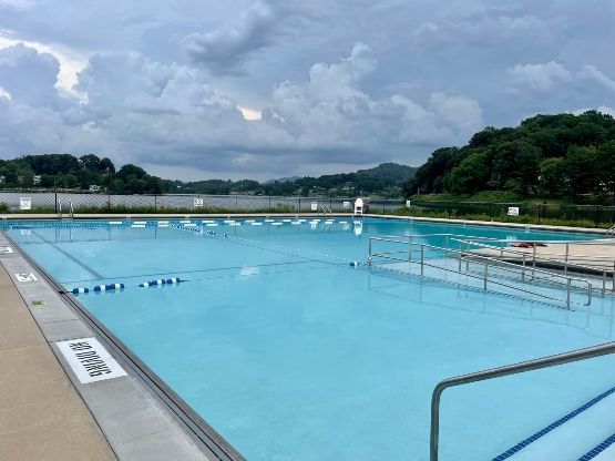 A large swimming pool with a no diving sign on the side of it.