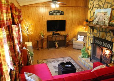 A living room with a fireplace and a flat screen tv