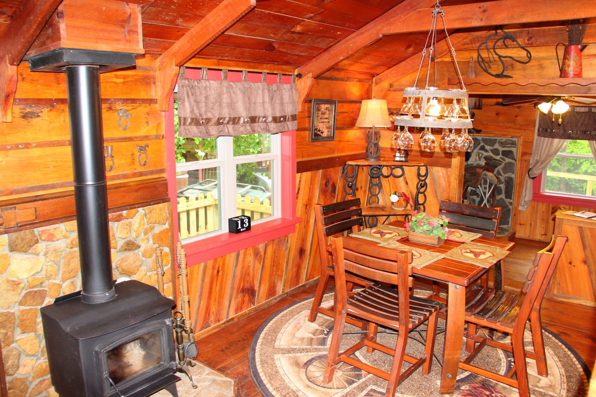 A dining room in a log cabin with a table and chairs