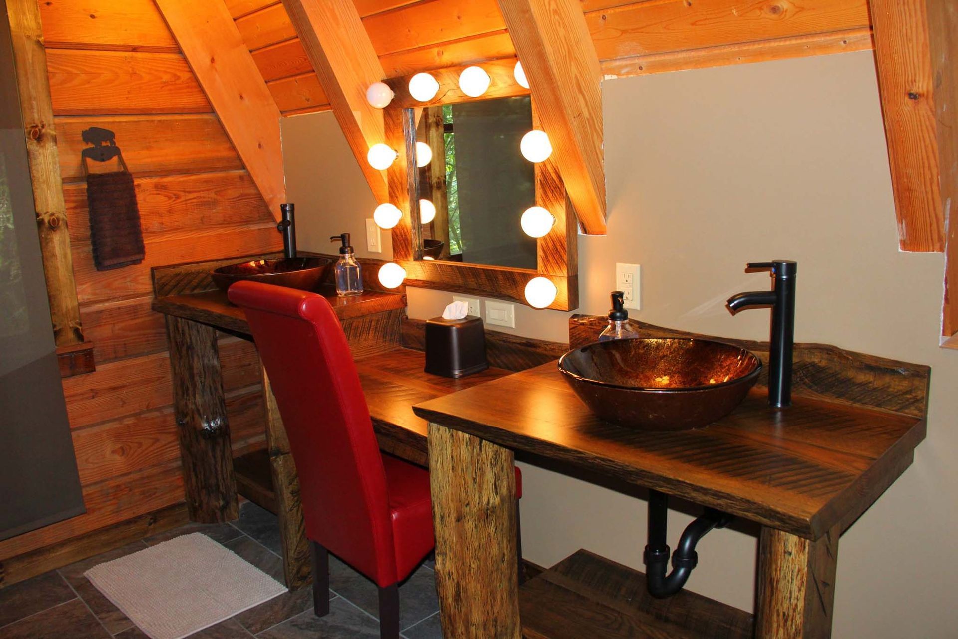 A bathroom with two sinks and a mirror.