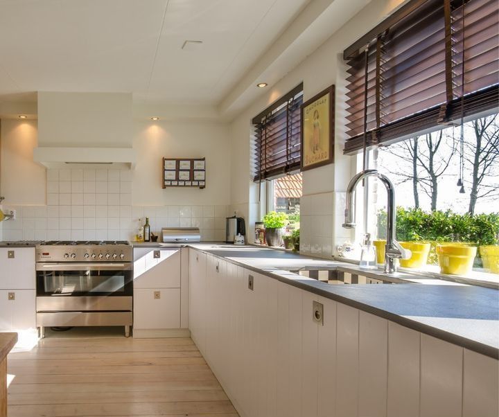 A kitchen with stainless steel appliances and white cabinets