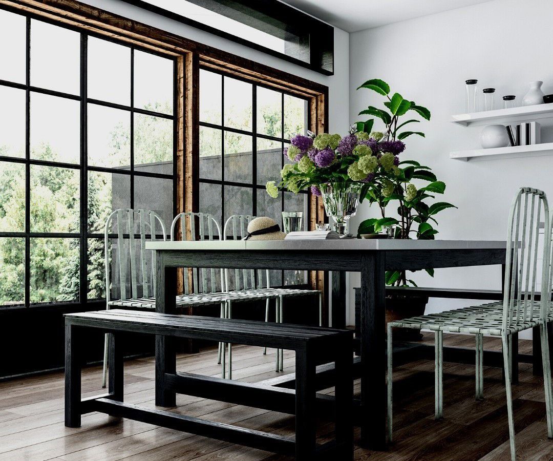 A dining room with a table and chairs and a bench.