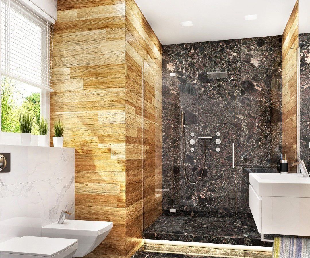 A bathroom with a walk in shower , sink , toilet and bidet.