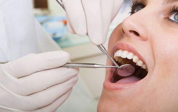 Dentist checking a woman-s teeth