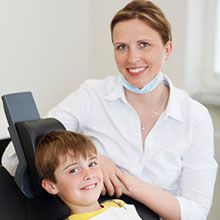 Dentist and patient also smiling