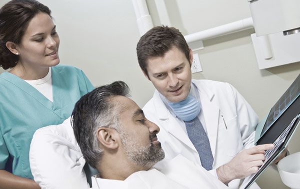Dentist showing denture model images