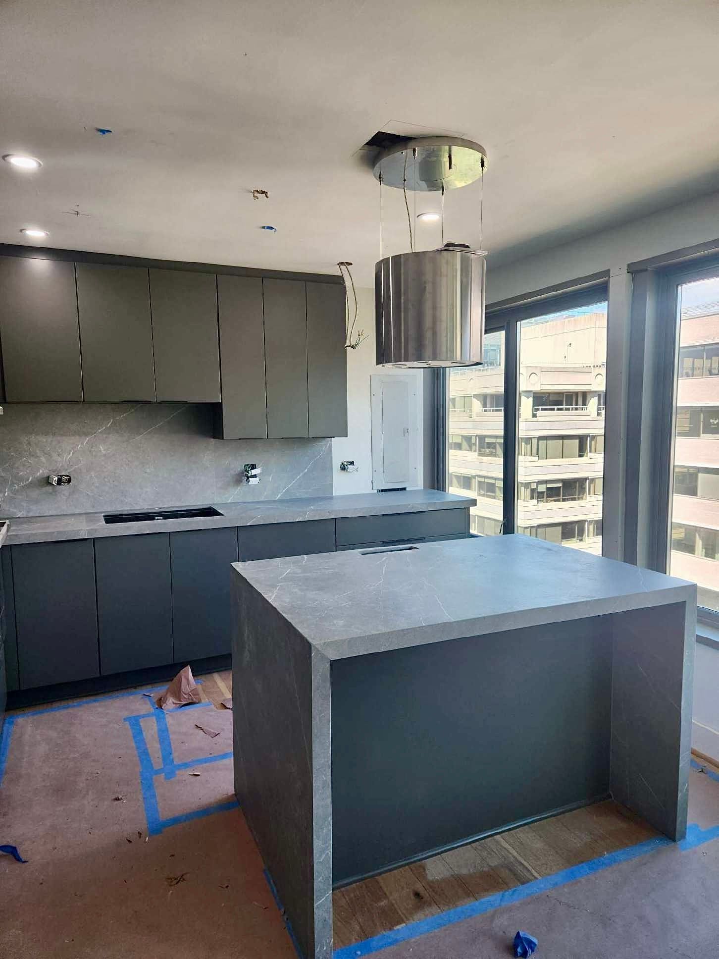 A kitchen with a large island in the middle of it.