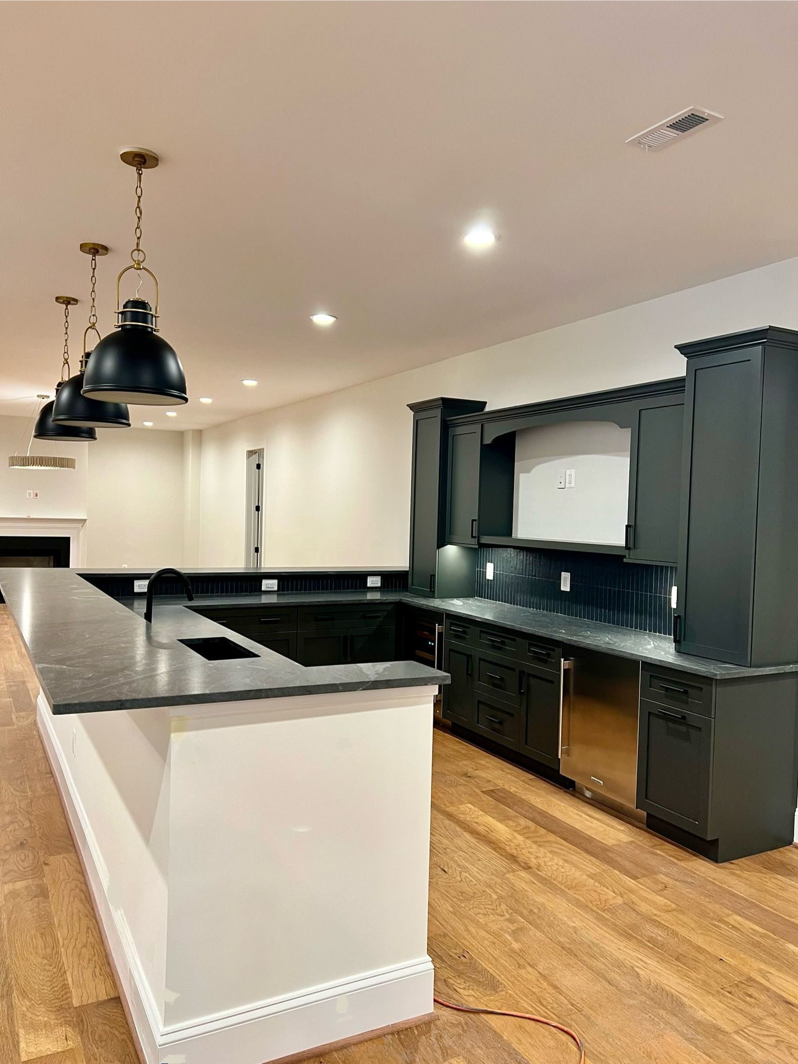 There is a large island in the middle of the kitchen.