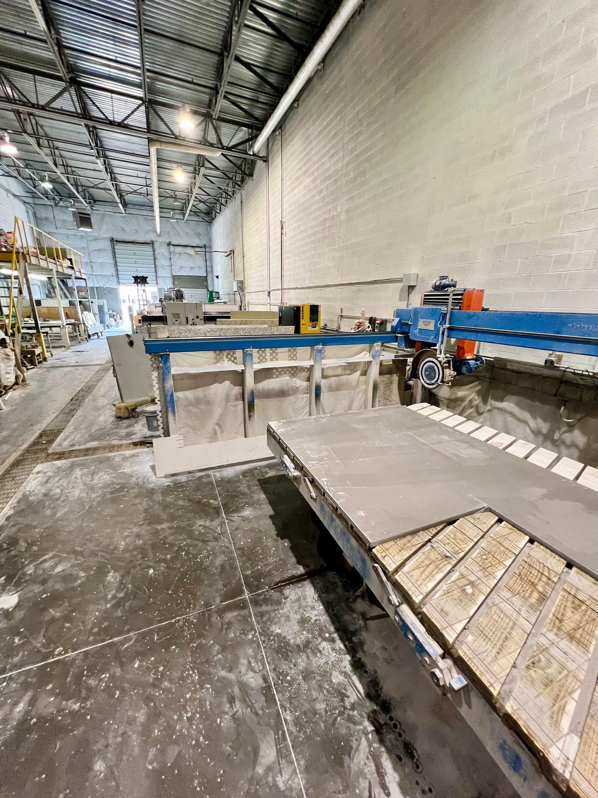 A large warehouse with a lot of machinery in it.