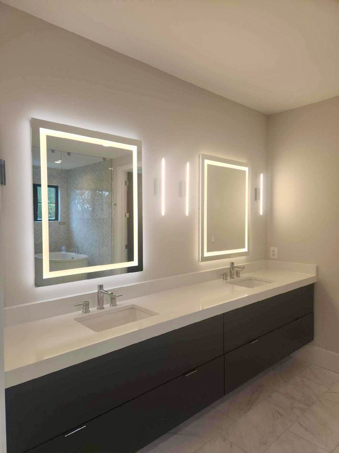 A bathroom with two sinks and two mirrors.