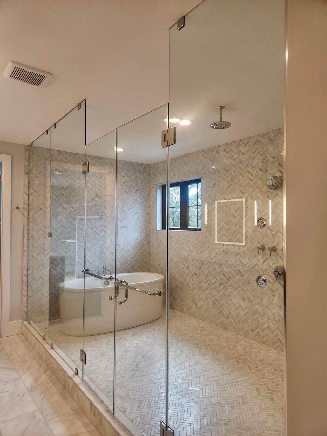 A bathroom with a bathtub and a walk in shower.