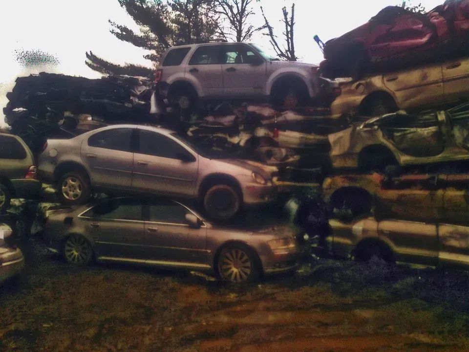 A bunch of cars are stacked on top of each other