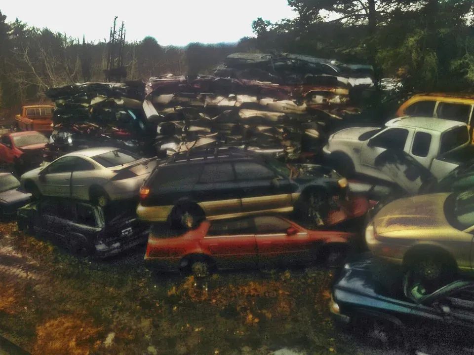 A bunch of cars are stacked on top of each other
