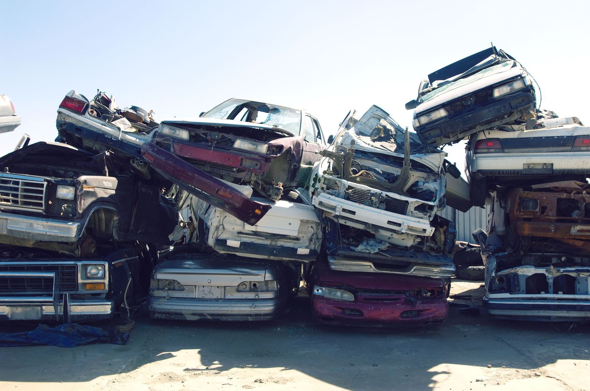 A bunch of cars are stacked on top of each other