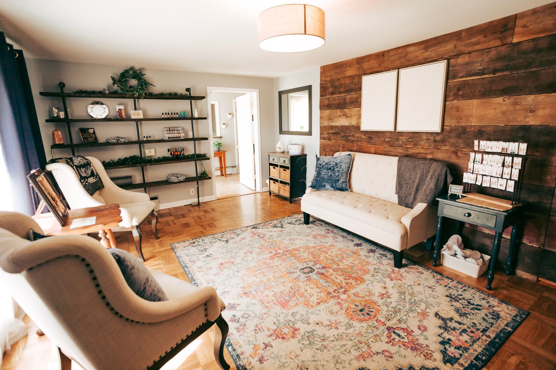 A living room with a couch , chairs , and a rug.