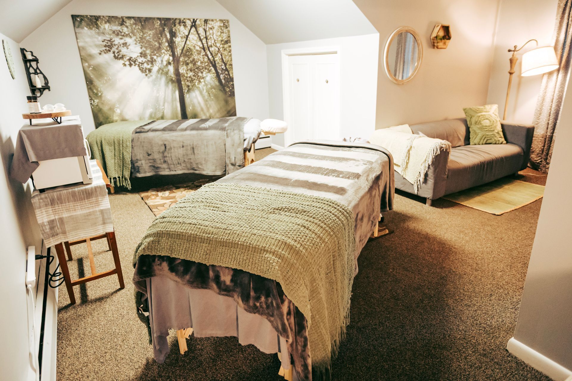 A room with two beds and a couch in it