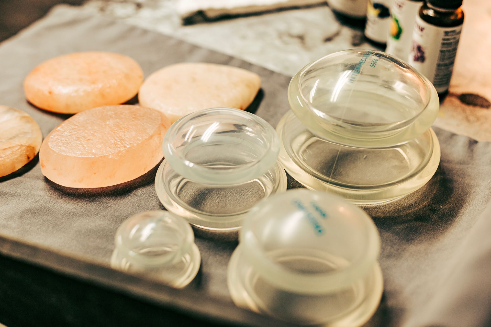 There are many different types of cups and stones on the table.