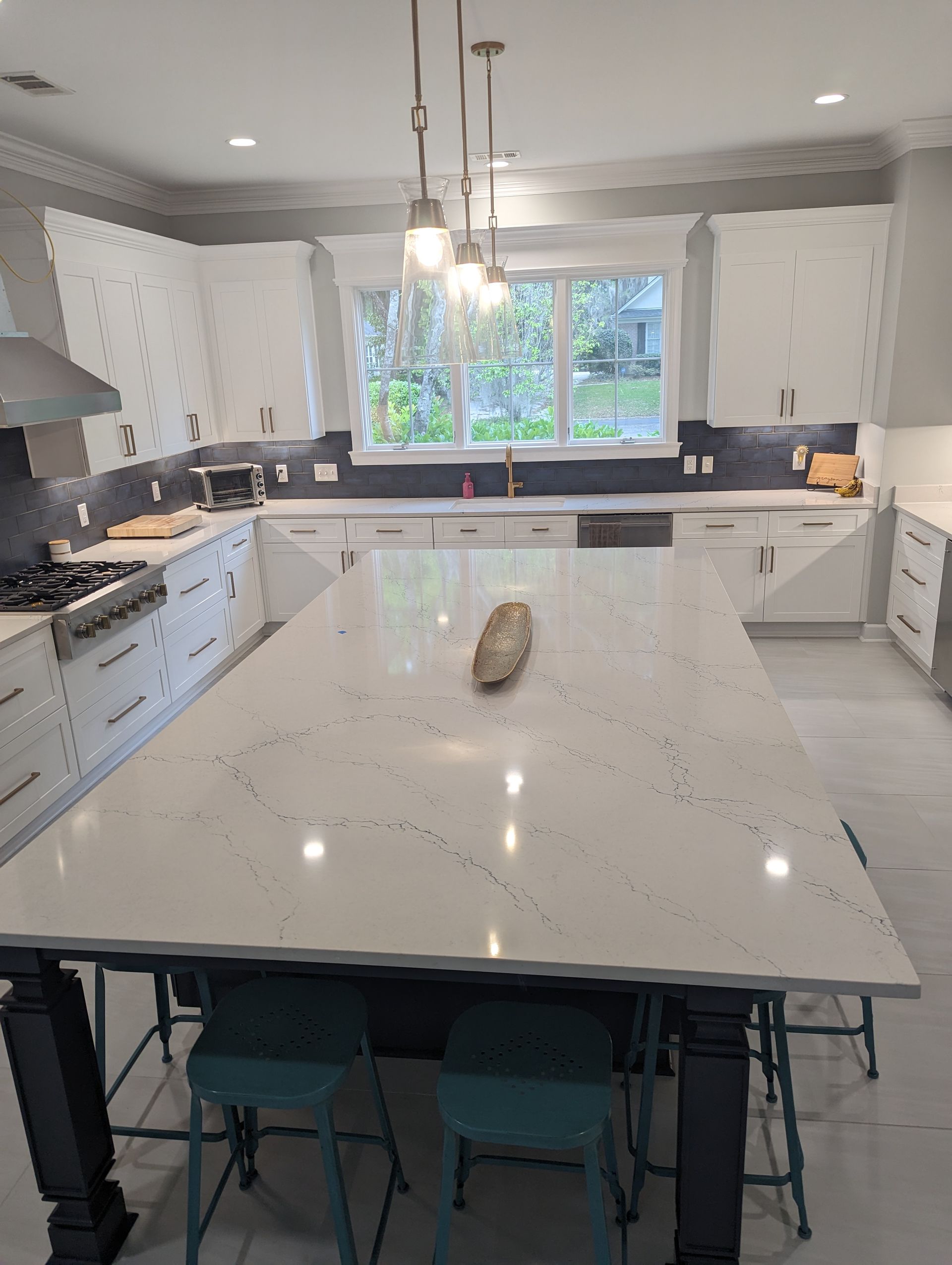 There is a large island in the middle of the kitchen.